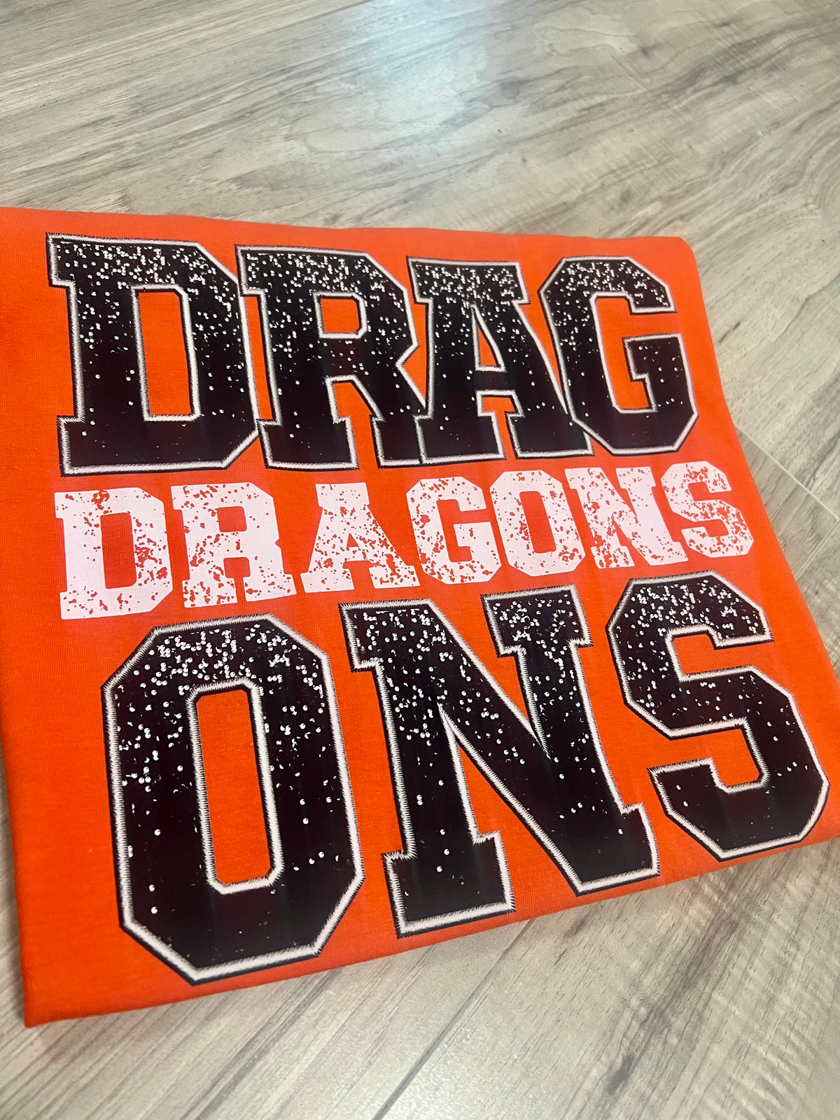 Dragons Faux Sequin and Embroidery design shown on a shirt, Dewar, Oklahoma
