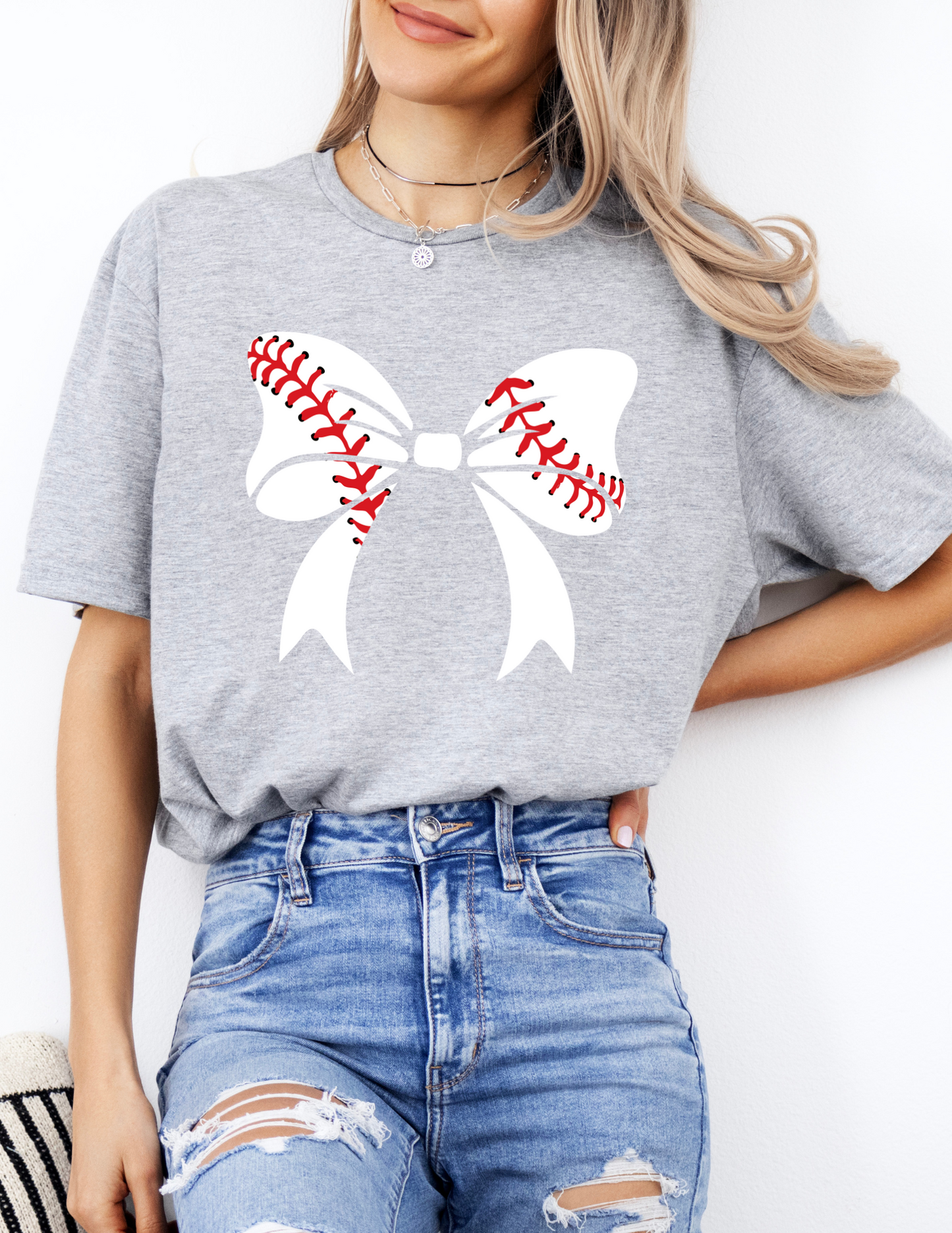 a woman wearing a baseball shirt with a bow