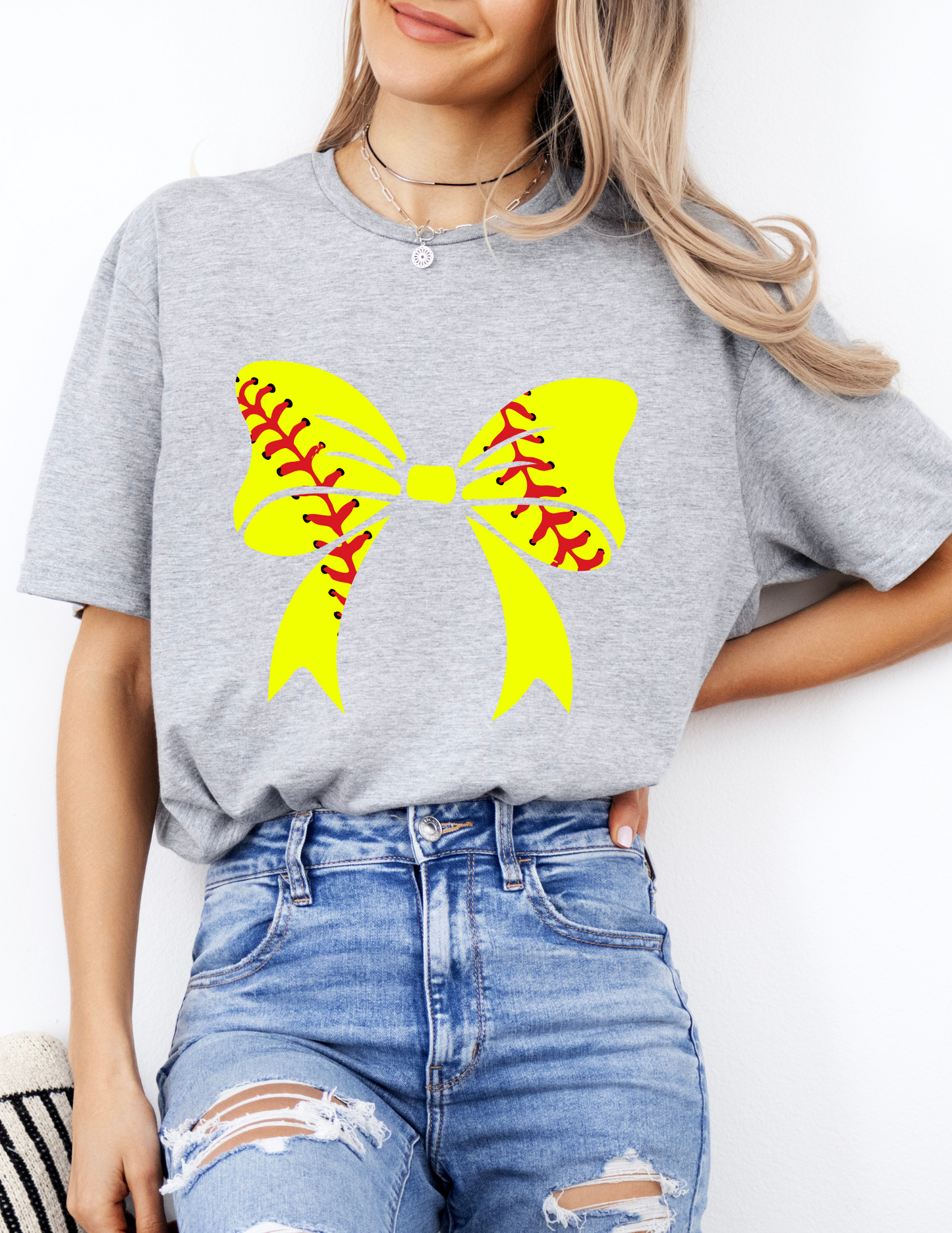 a woman wearing a t - shirt with a softball design on it