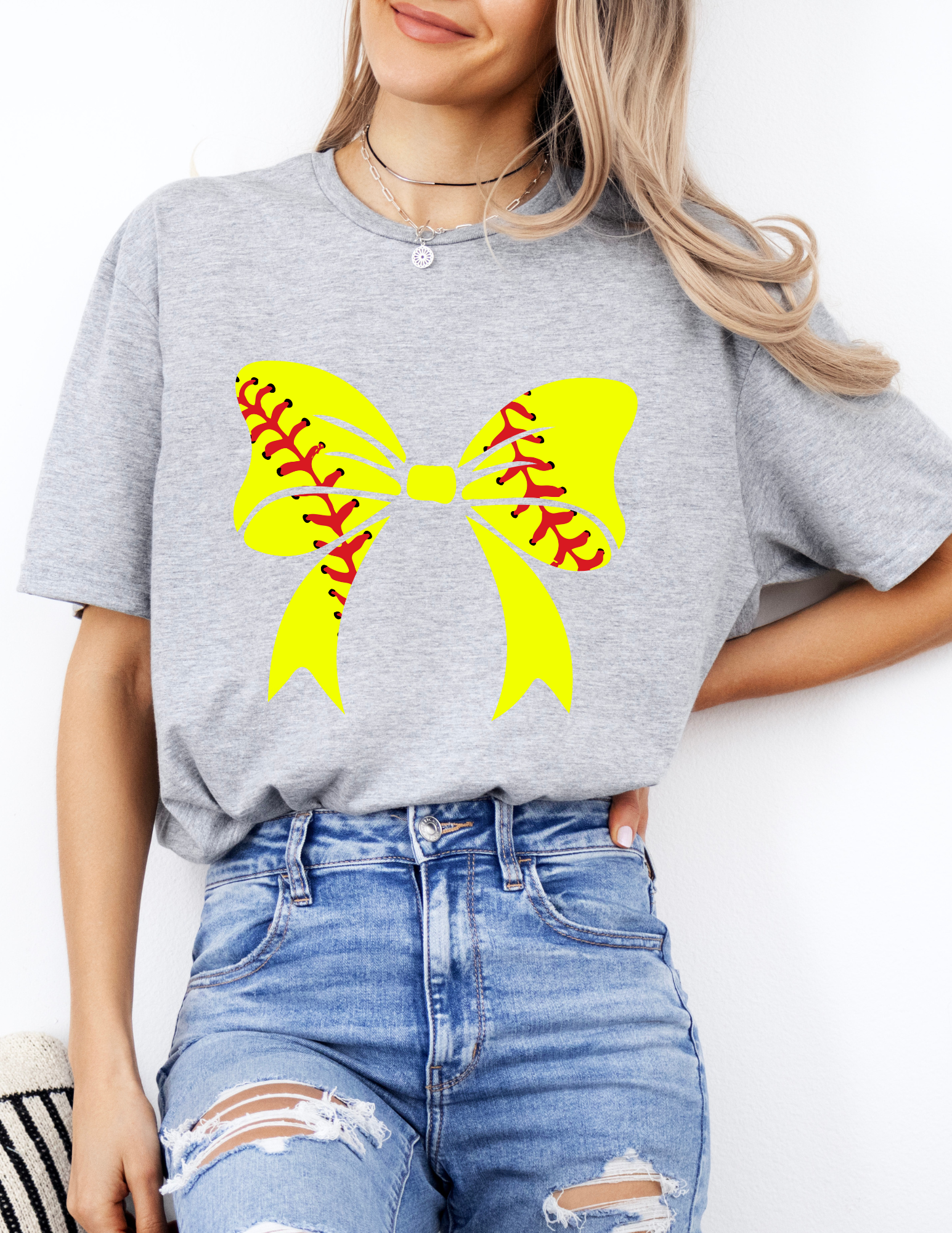 a woman wearing a t - shirt with a softball design on it