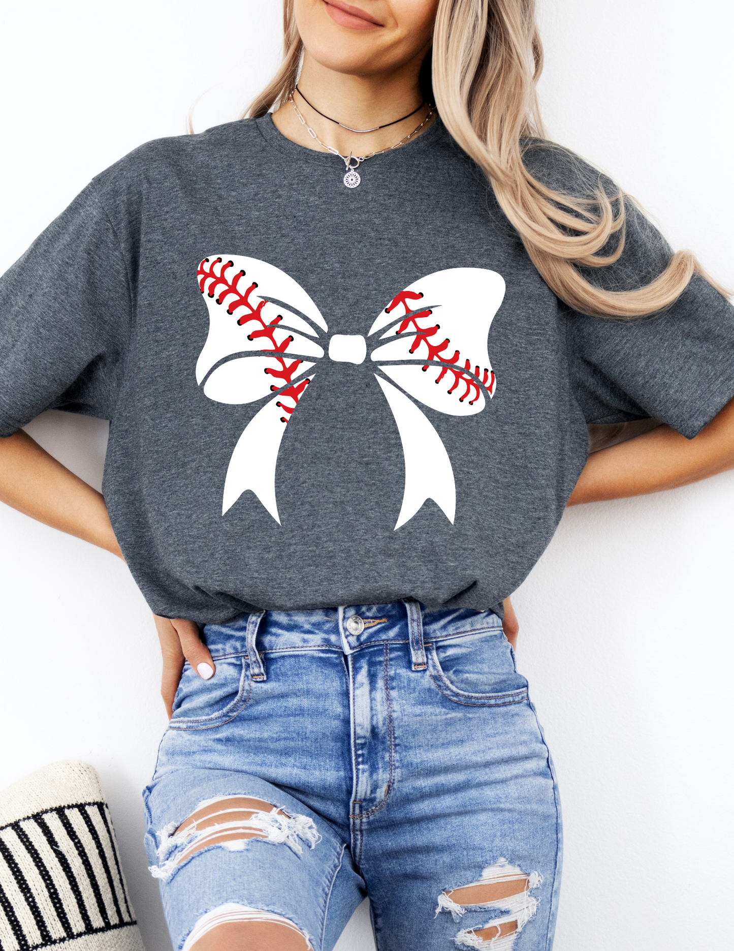 a woman wearing a baseball sweater with a bow