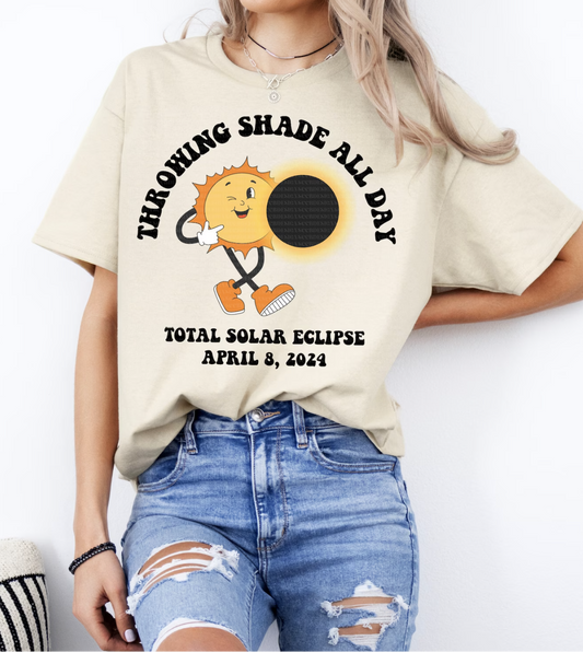 a woman wearing a t - shirt with a solar eclipse on it